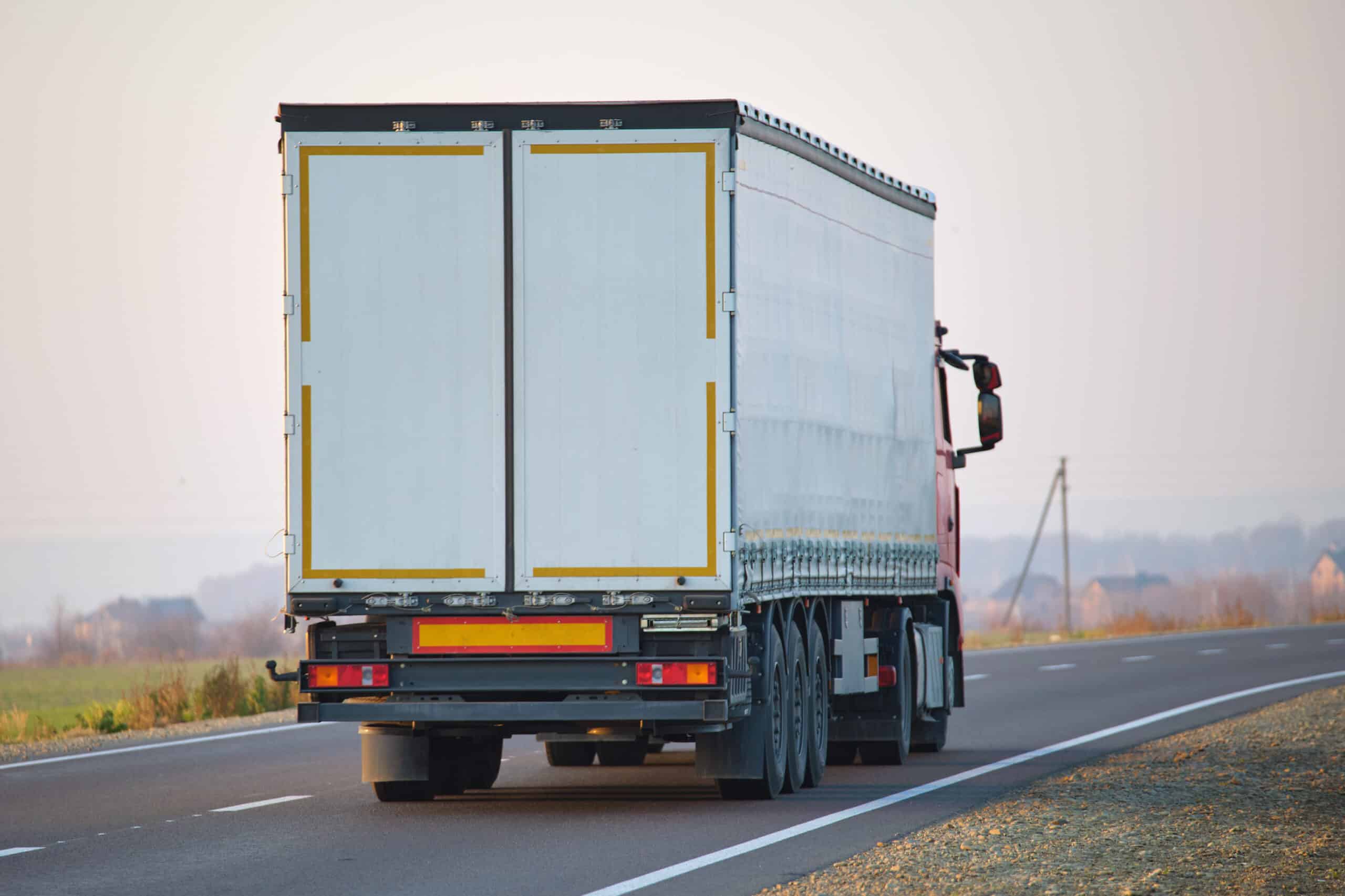 Semi-truck with cargo trailer driving on highway hauling goods in evening. Delivery transportation and logistics concept floor braces